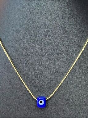 Murano glass Turkish evil eye pendant with 14k gold plated bead necklace.